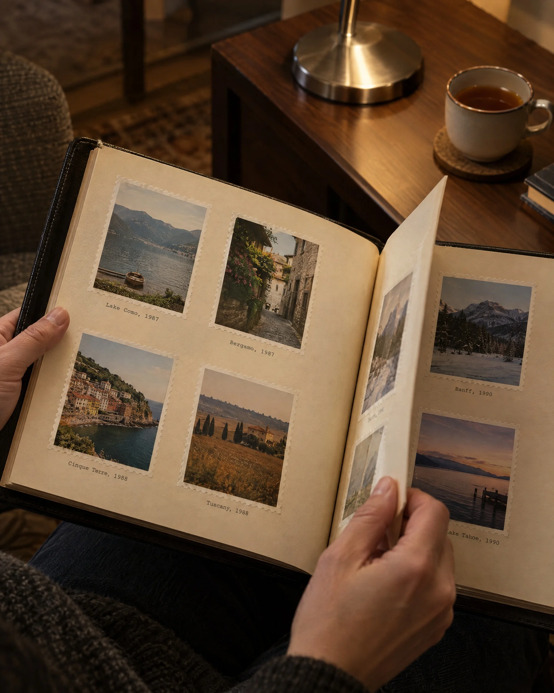 Hands turning the album’s pages by lamplight.